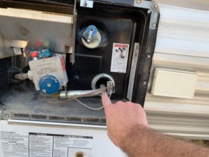RV Hot Water heater pointing out pilot light and gas inlet area