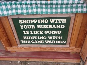 wooden sign about shopping with husband