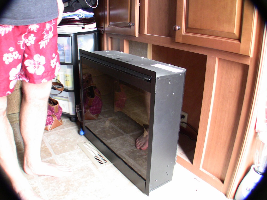 RV fireplace showing unit removed from mounting location